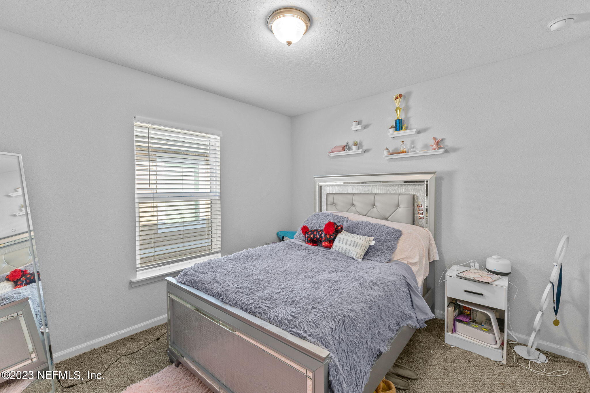 1592 Liberty Tree Place Jacksonville, FL 32221 - Photo 18 of 28 a bedroom with a bed and a window