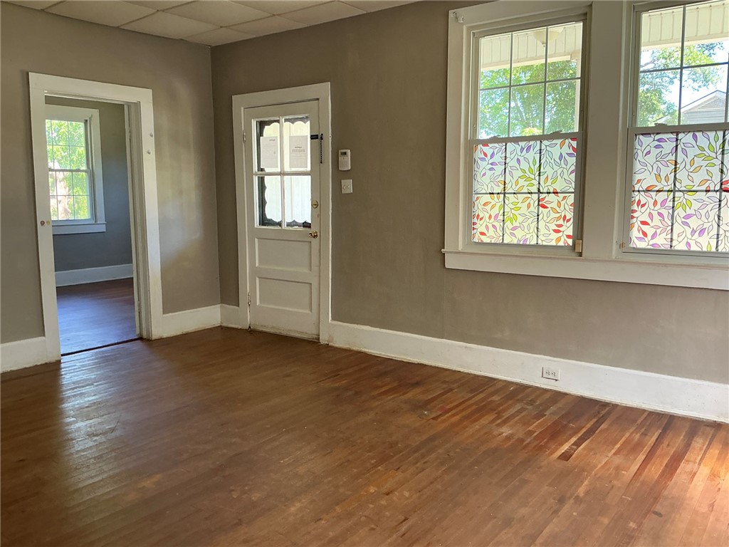 14 Ames Street Seneca, SC 29678 - Photo 3 of 15 This versatile room features warm wood flooring and abundant natural light through multiple windows.