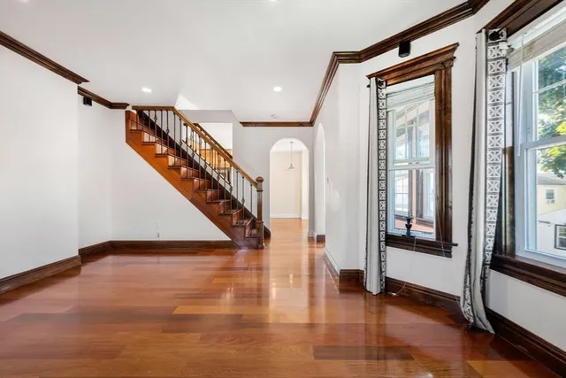 a view of entryway and hall with wooden floor