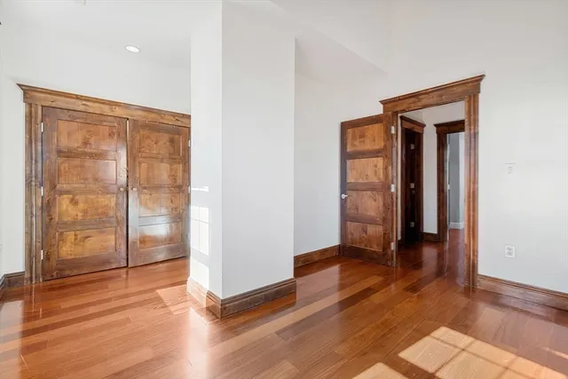 an empty room with wooden floor and closet