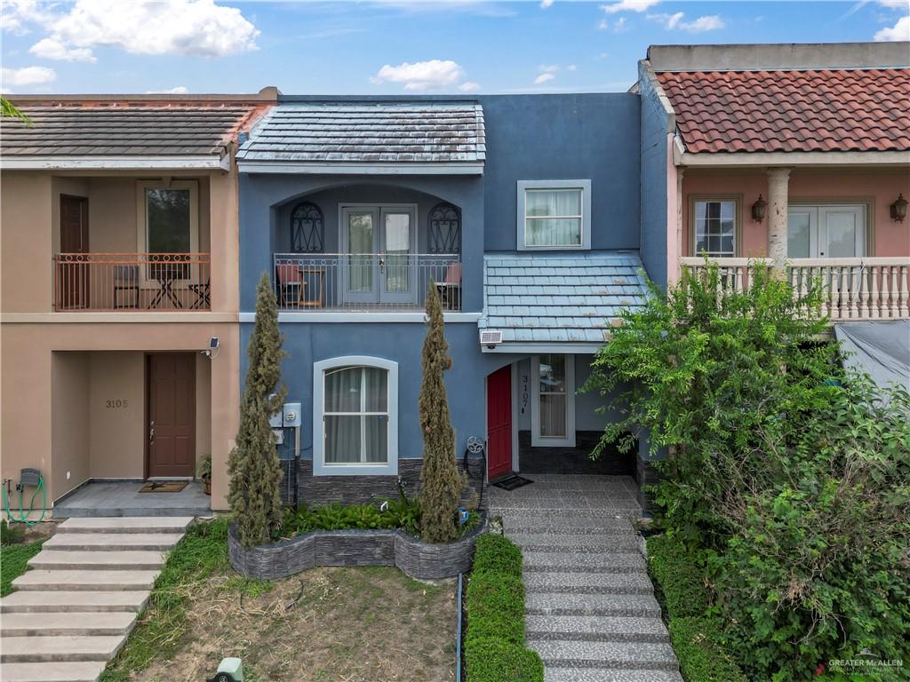a view of a house with a small yard and a large window