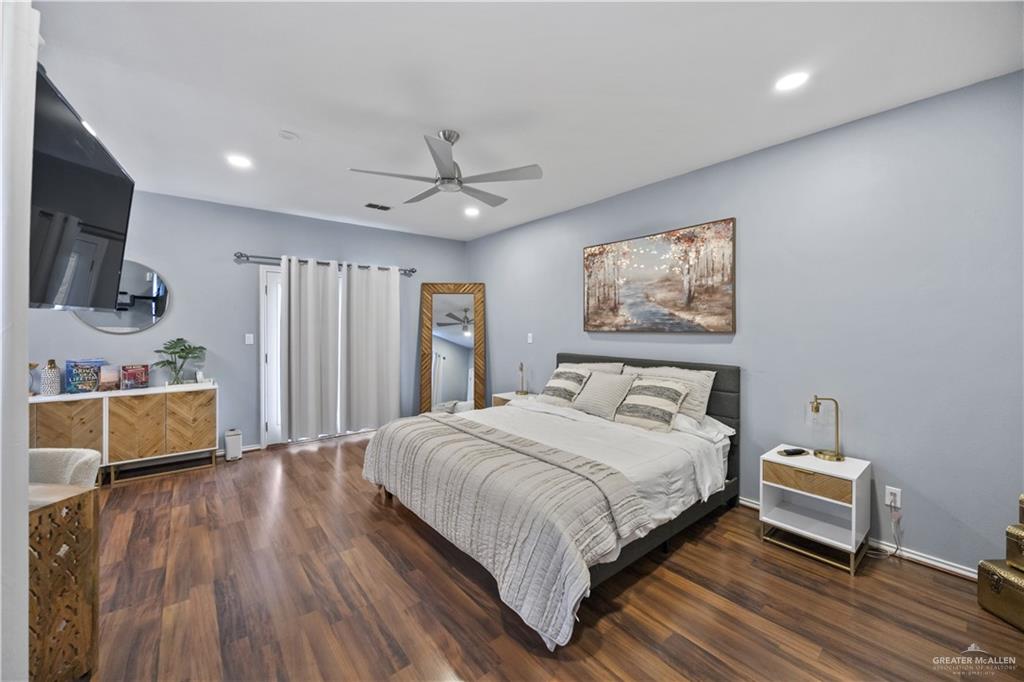 3107 South 6th Lane McAllen, TX 78503 - Photo 16 of 31 a bedroom with a bed a couch and a flat screen tv