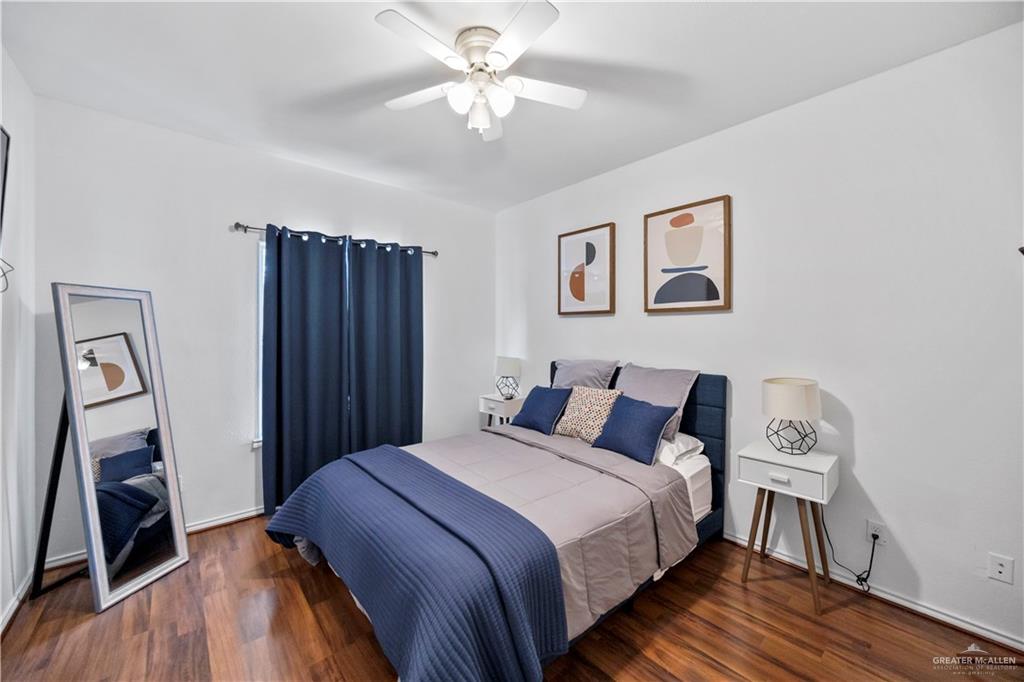 3107 South 6th Lane McAllen, TX 78503 - Photo 21 of 31 a bedroom with a large bed and a chandelier