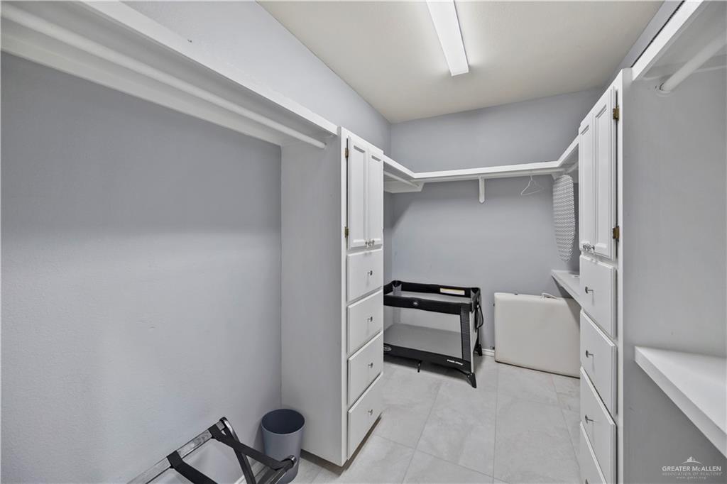 3107 South 6th Lane McAllen, TX 78503 - Photo 23 of 31 a view of walk in closet with clothes and shoes