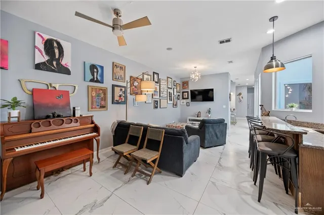 a living room with granite countertop furniture and a flat screen tv
