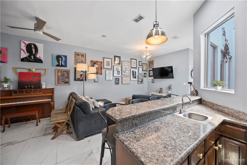 3107 South 6th Lane McAllen, TX 78503 - Photo 31 of 31 a living room with granite countertop furniture and a flat screen tv
