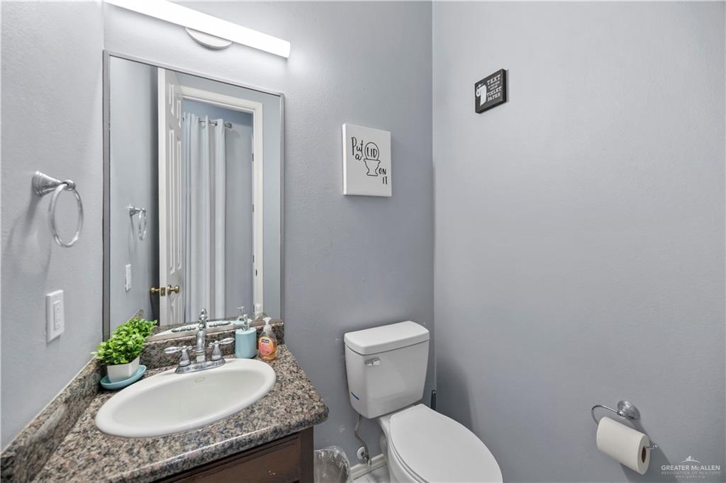 3107 South 6th Lane McAllen, TX 78503 - Photo 6 of 31 a bathroom with a granite countertop sink and a mirror