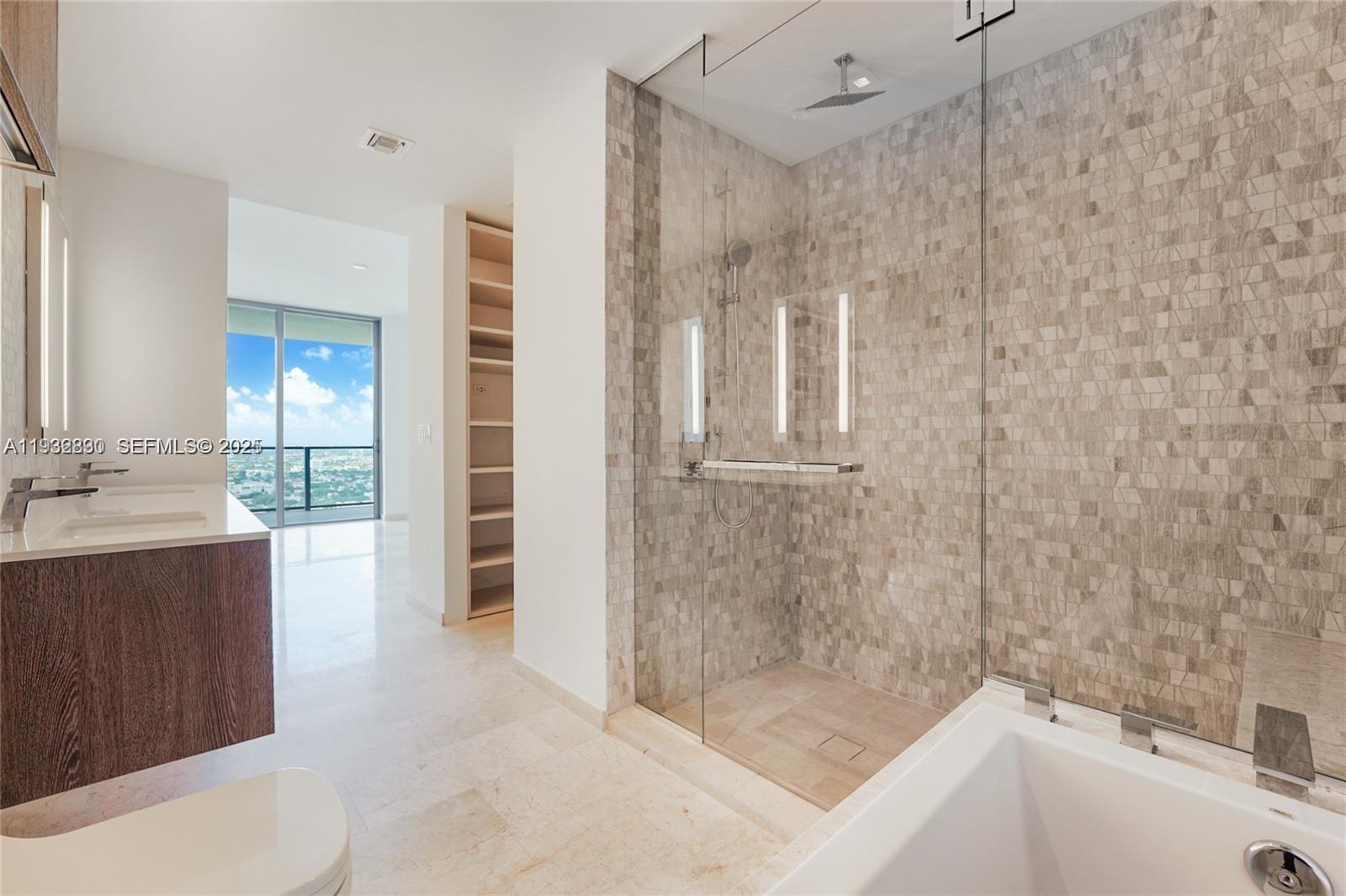 88 Southwest 7th Street, Unit 2708 Miami, FL 33130 - Photo 11 of 12 a bathroom with a bathtub and a sink
