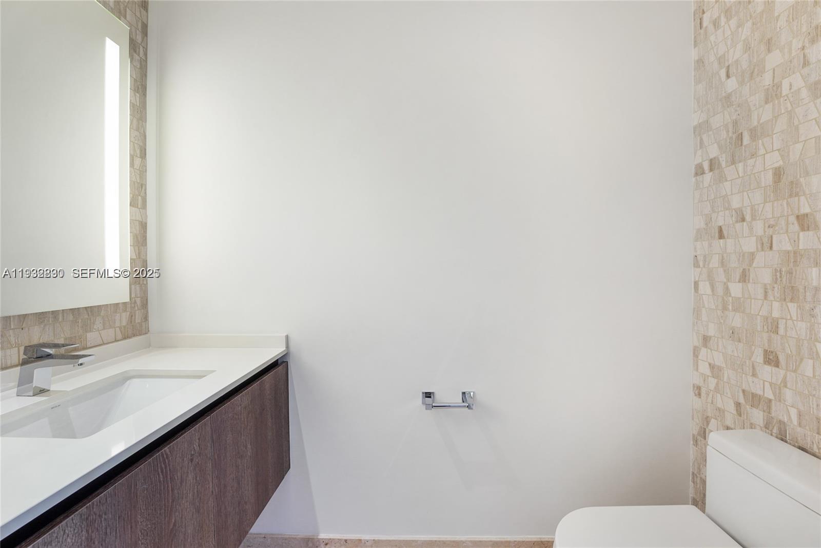 88 Southwest 7th Street, Unit 2708 Miami, FL 33130 - Photo 12 of 12 a bathroom with a sink a toilet and a mirror