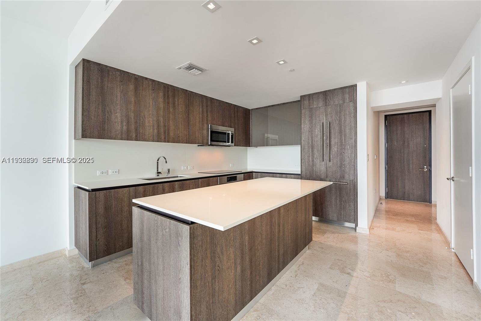 88 Southwest 7th Street, Unit 2708 Miami, FL 33130 - Photo 4 of 12 a kitchen with stainless steel appliances granite countertop a sink a stove a refrigerator and a microwave oven