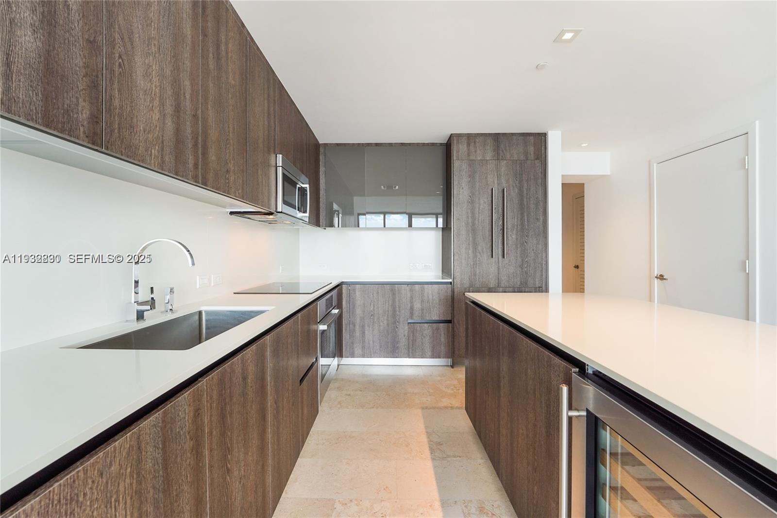 88 Southwest 7th Street, Unit 2708 Miami, FL 33130 - Photo 5 of 12 a kitchen with sink cabinets and wooden floor