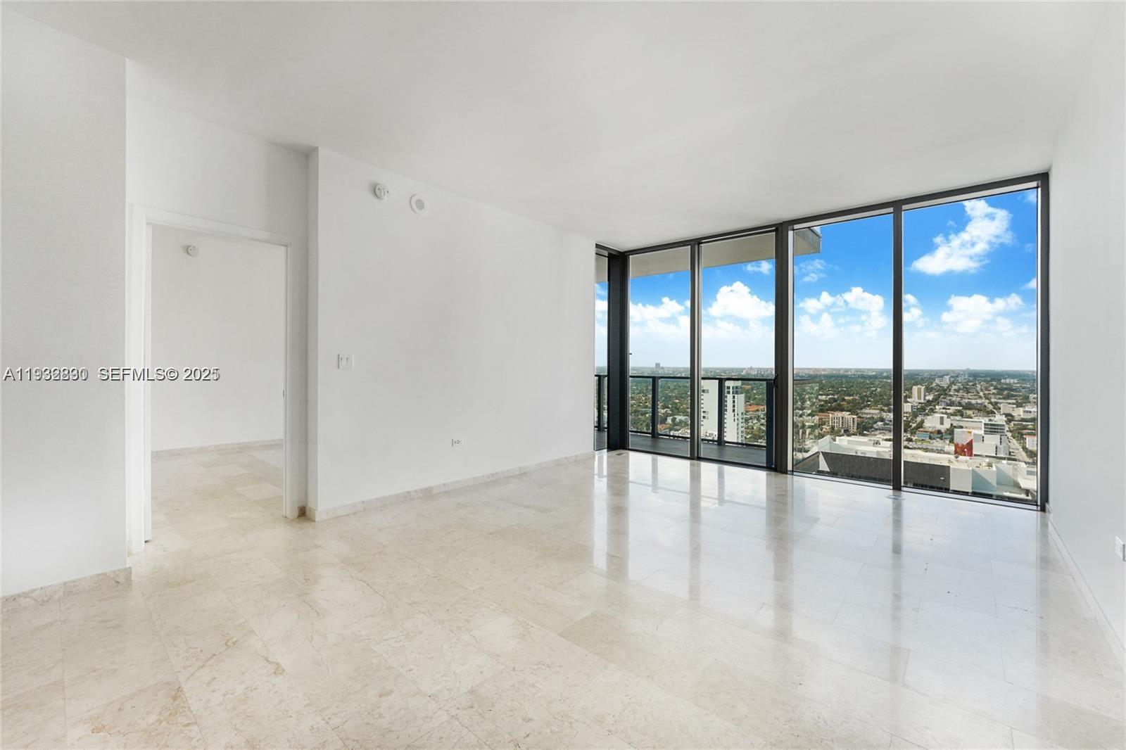 88 Southwest 7th Street, Unit 2708 Miami, FL 33130 - Photo 7 of 12 wooden floor in an empty room with a sliding door