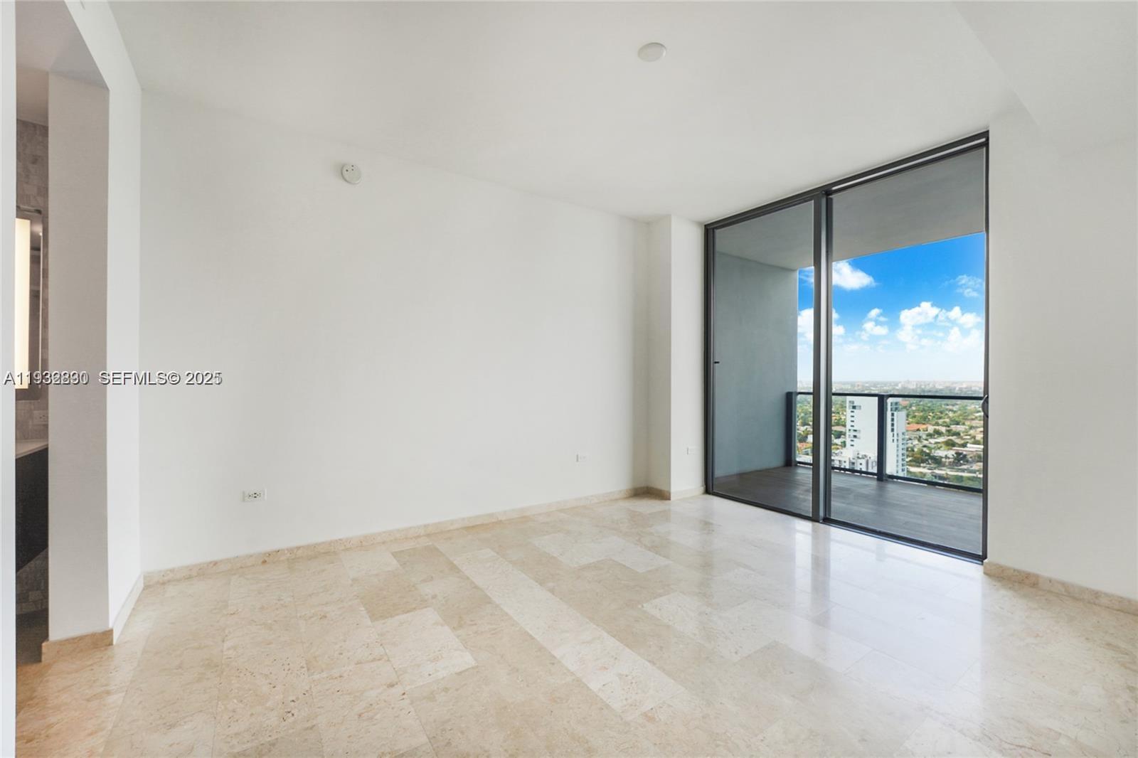 88 Southwest 7th Street, Unit 2708 Miami, FL 33130 - Photo 8 of 12 a view of an empty room with a window