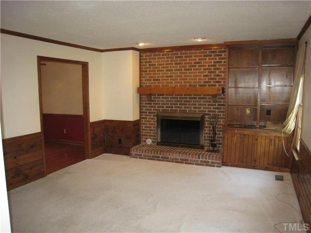 3505 East Jameson Road Raleigh, NC 27604 - Photo 3 of 14 Large living room with fireplace and built in bookcase