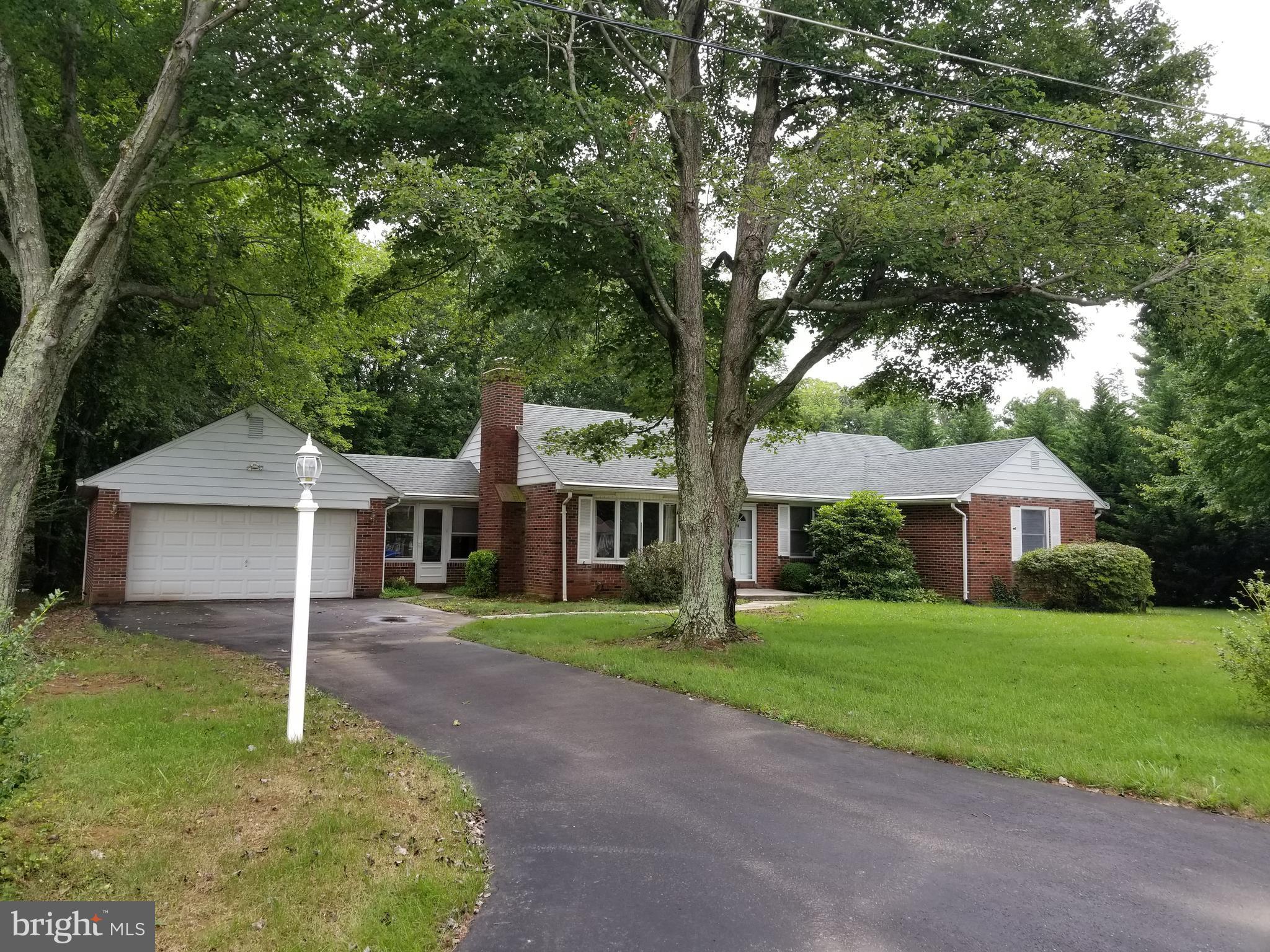 5 Upland Road Fallston, MD 21047 - Photo 1 of 8 a front view of a house with a garden and trees