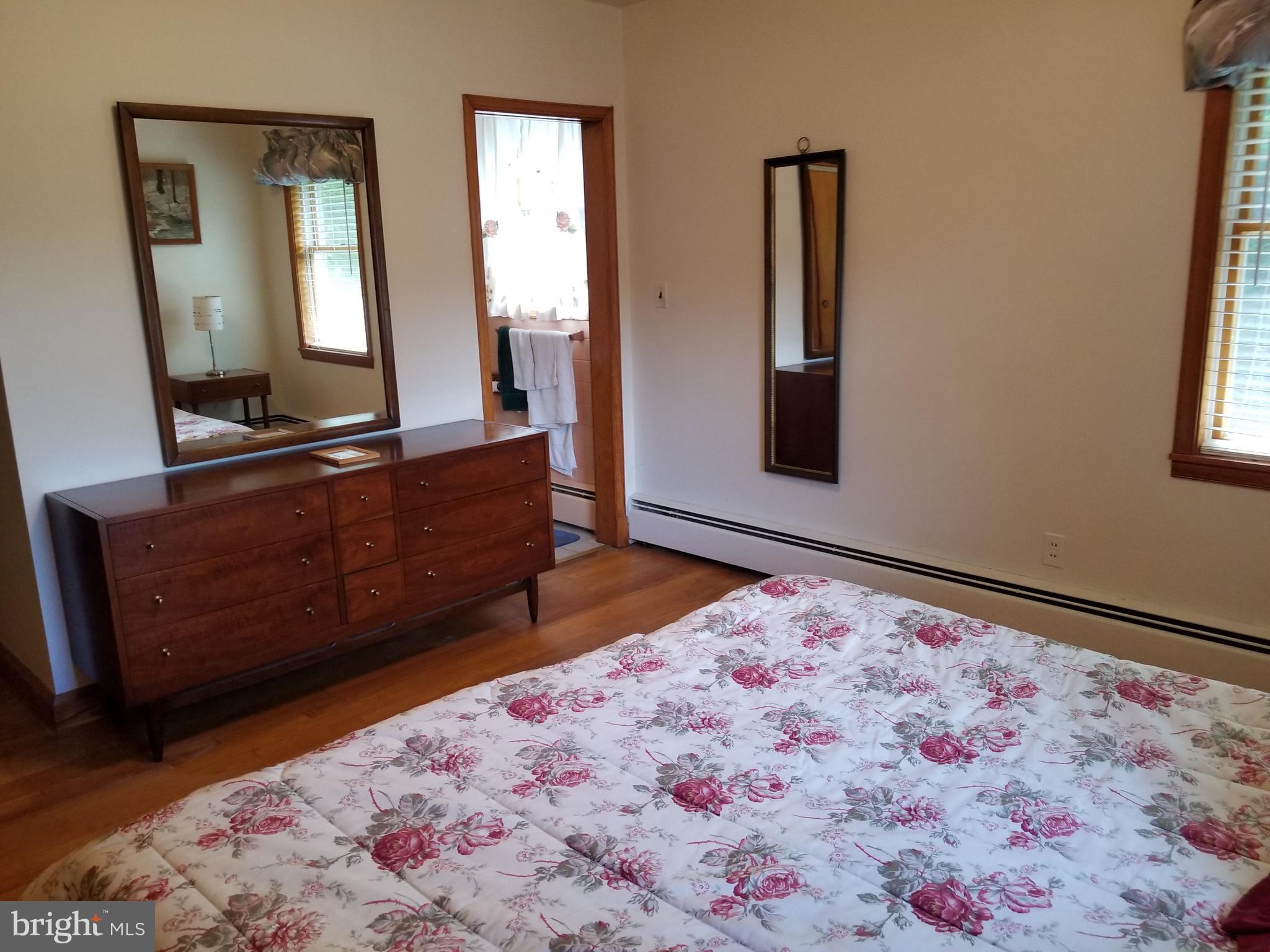 5 Upland Road Fallston, MD 21047 - Photo 7 of 8 a bed room with a bed mirror and a dresser