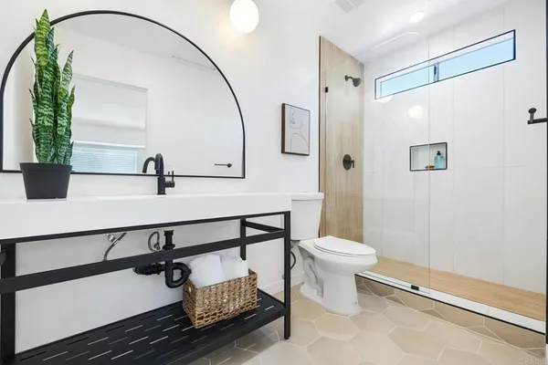 a bathroom with a sink toilet and shower