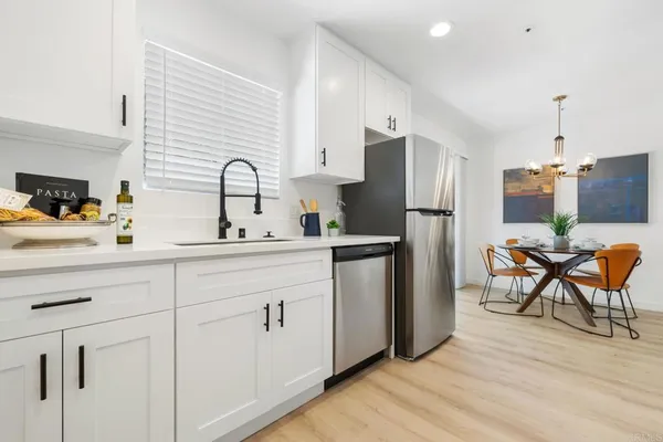 a kitchen with a sink cabinets and refrigerator