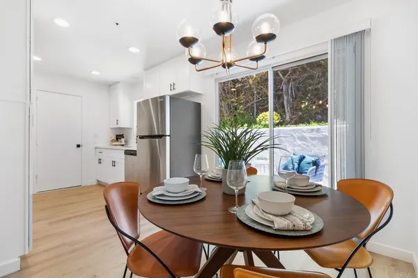 a view of a dining room with furniture wooden floor and chandelier