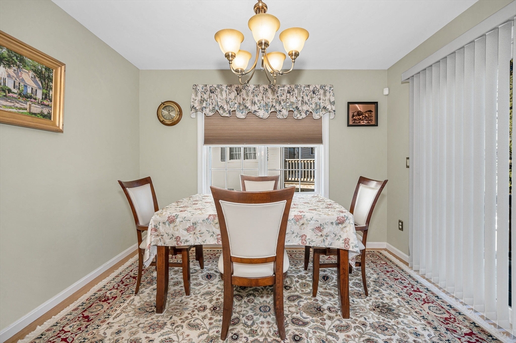 262 Littleton Road, Unit 14 Chelmsford, MA 01824 - Photo 14 of 30 a view of a dining room with furniture and chandelier