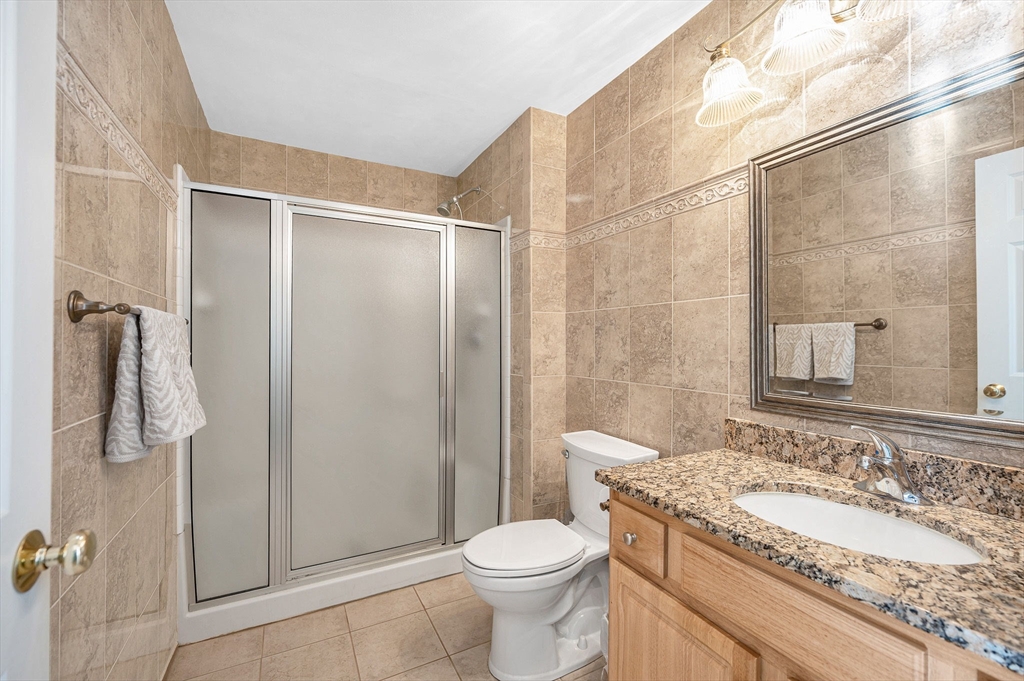 262 Littleton Road, Unit 14 Chelmsford, MA 01824 - Photo 17 of 30 a bathroom with a granite countertop sink toilet and shower