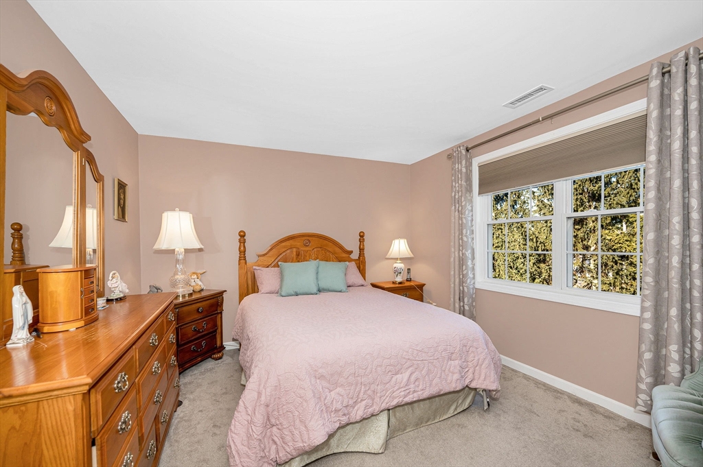 262 Littleton Road, Unit 14 Chelmsford, MA 01824 - Photo 18 of 30 a bedroom with a bed and a window