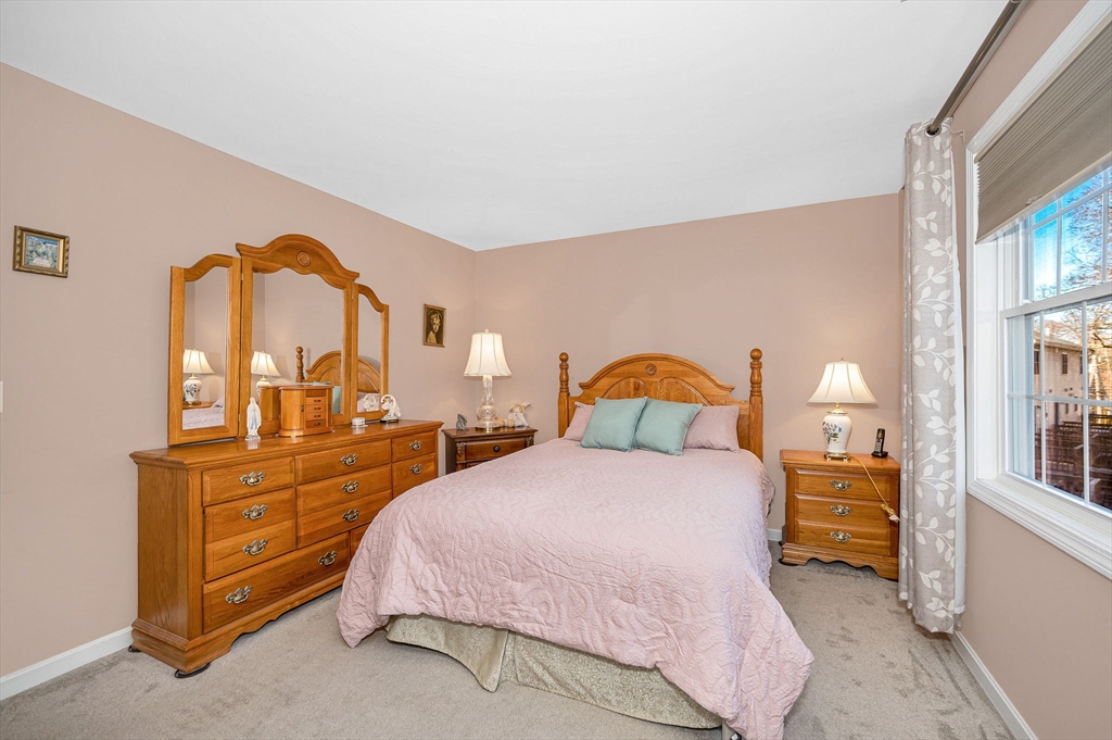 262 Littleton Road, Unit 14 Chelmsford, MA 01824 - Photo 19 of 30 a bedroom with a bed and a dresser