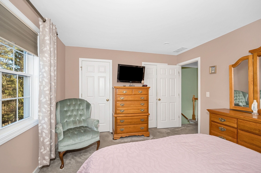 262 Littleton Road, Unit 14 Chelmsford, MA 01824 - Photo 20 of 30 a bedroom with a bed and furniture
