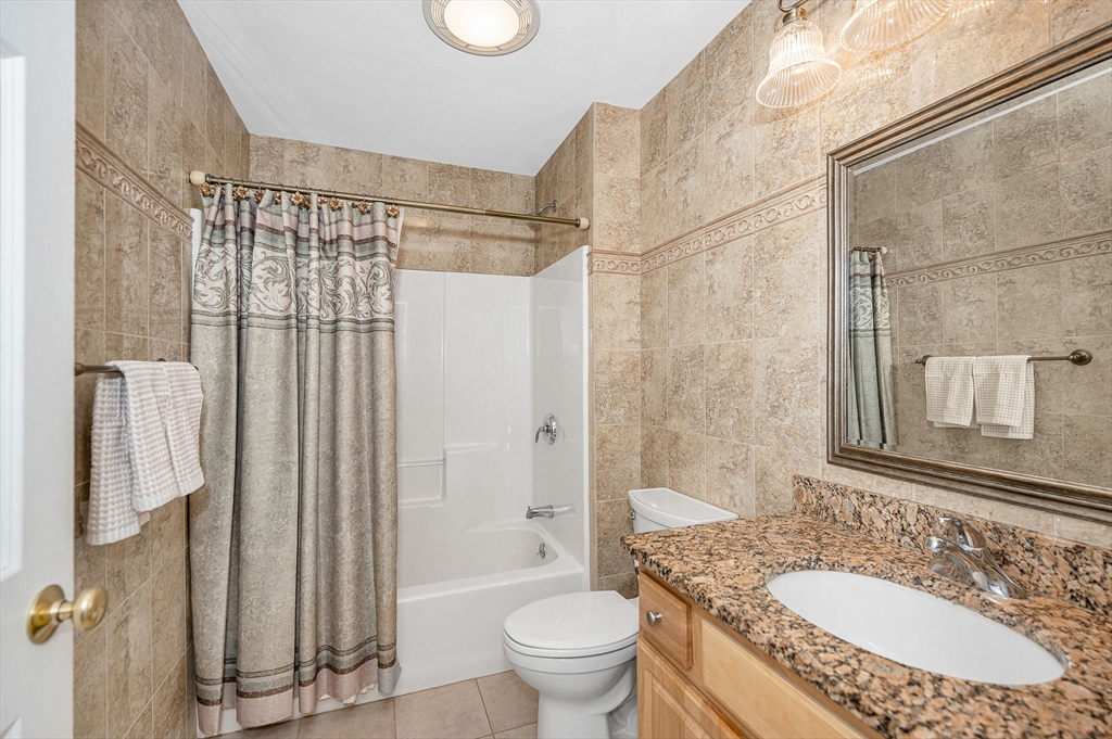 262 Littleton Road, Unit 14 Chelmsford, MA 01824 - Photo 21 of 30 a bathroom with a granite countertop sink toilet and shower