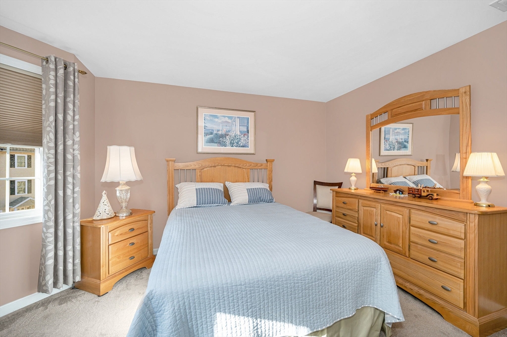 262 Littleton Road, Unit 14 Chelmsford, MA 01824 - Photo 23 of 30 a bedroom with a bed and a dresser in it