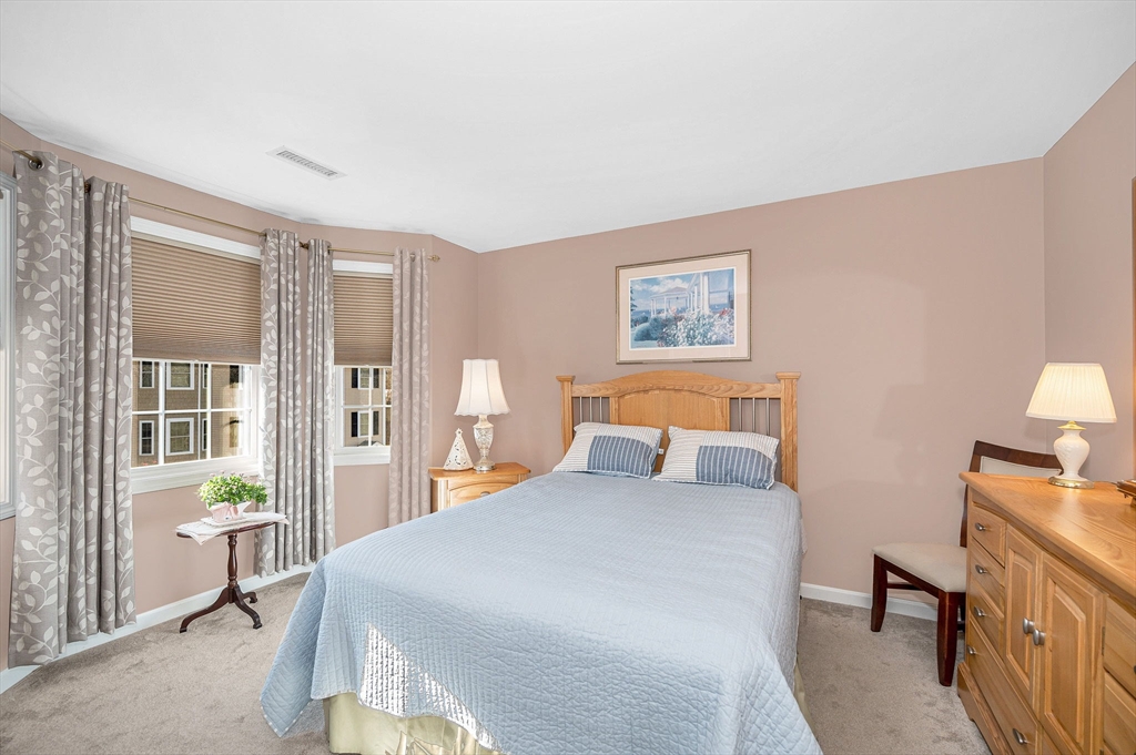 262 Littleton Road, Unit 14 Chelmsford, MA 01824 - Photo 24 of 30 a bed room with a bed and a lamp