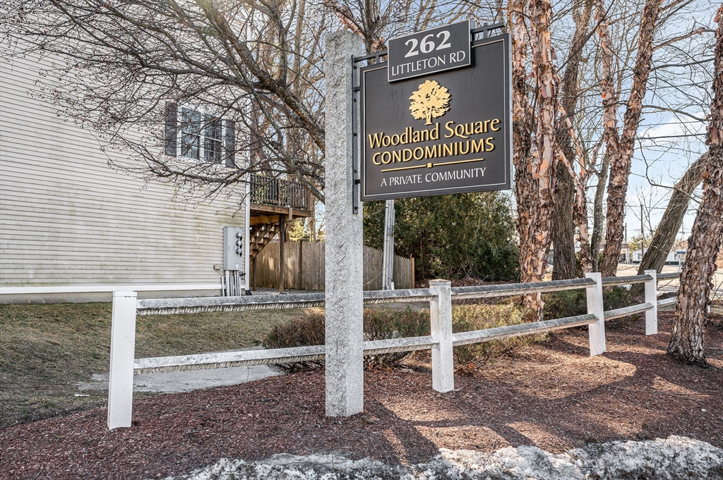 262 Littleton Road, Unit 14 Chelmsford, MA 01824 - Photo 30 of 30 street sign on a sidewalk next to a road