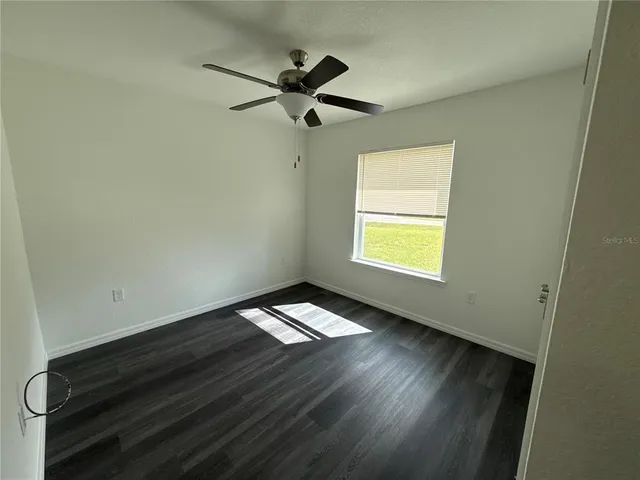 a view of an empty room and wooden floor