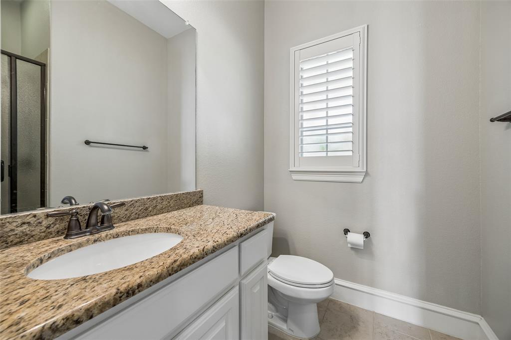134 Santa Rosa Way Irving, TX 75062 - Photo 17 of 26 Well-appointed secondary bath featuring granite countertops and a tub/shower combination.