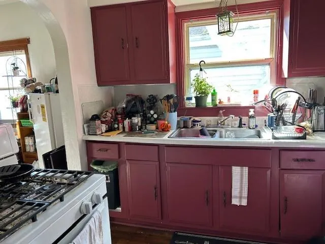 a kitchen with wooden cabinets and a stove top oven