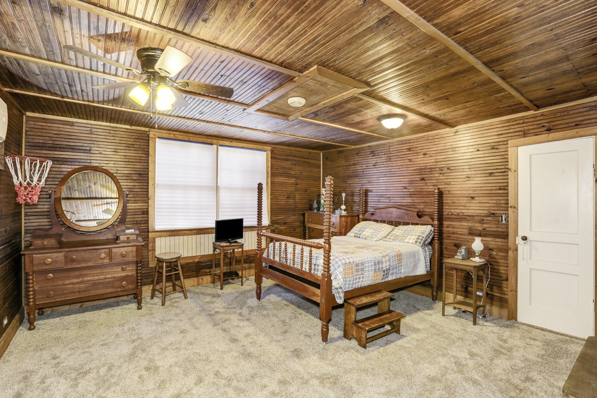 27 Bee Spring Road Dellrose, TN 38453 - Photo 21 of 30 a bedroom with a bed a desk and chair