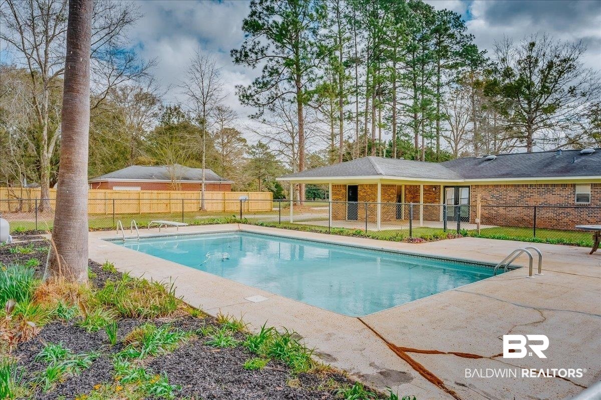 440 Dykes Road Mobile, AL 36608 - Photo 34 of 49 View of pool with a diving board, a fenced in pool, fence, and a patio area