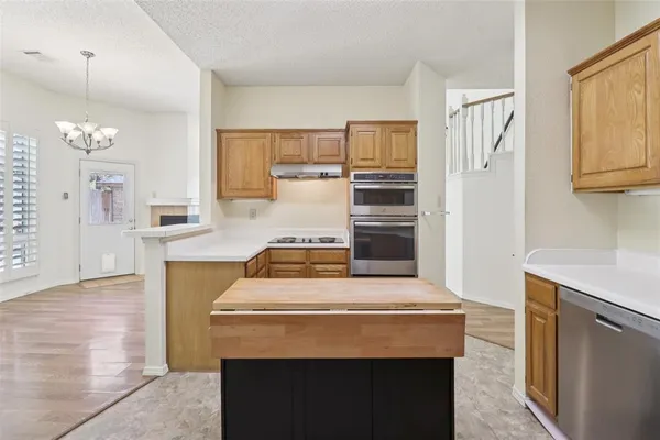 a kitchen with stainless steel appliances granite countertop a stove and a refrigerator