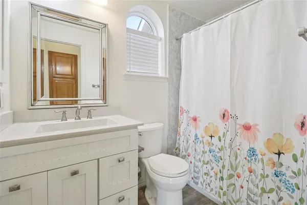 a bathroom with a sink toilet and shower