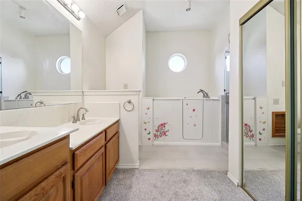a spacious bathroom with a double vanity sink mirror and