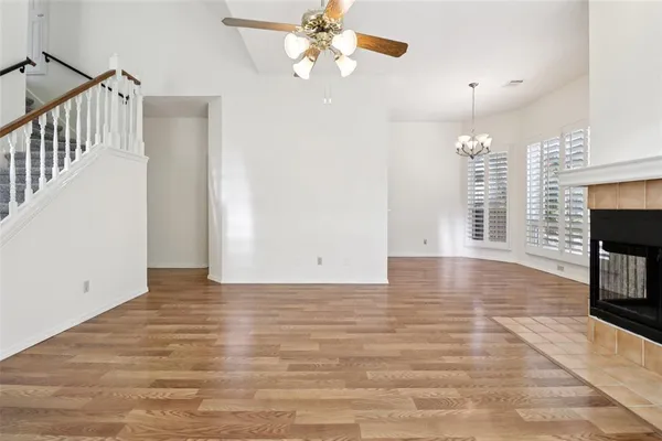 a view of an empty room with window and fireplace