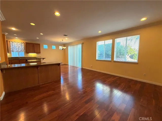 a view of kitchen with granite countertop window and wooden floor