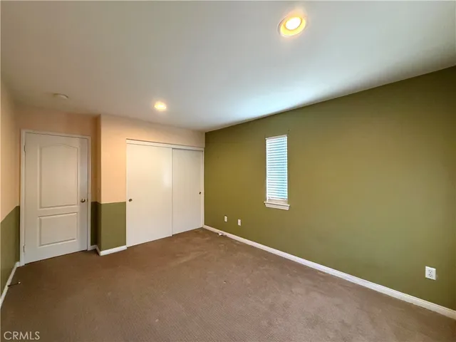 an empty room with a empty space and windows