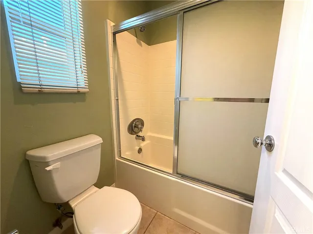 a white toilet sitting next to a bath tub
