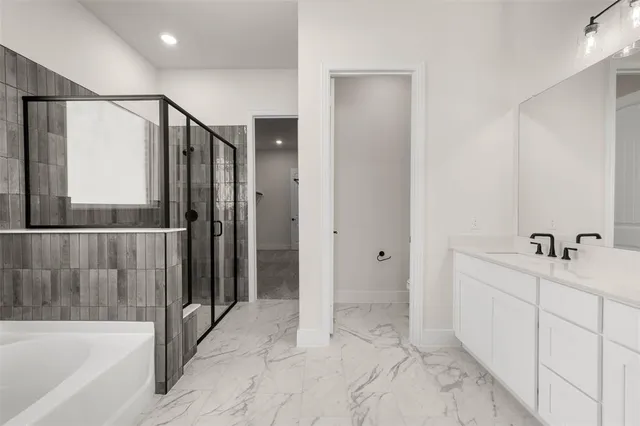 a bathroom with a tub and a shower