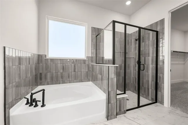 a bathroom with a double vanity sink a mirror and a bathtub