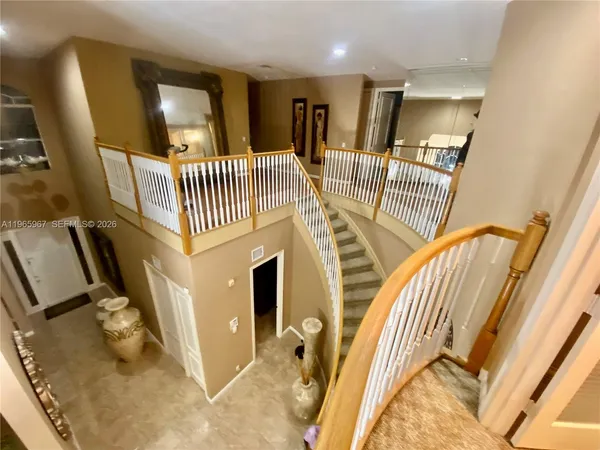 a view of a livingroom with furniture and staircase