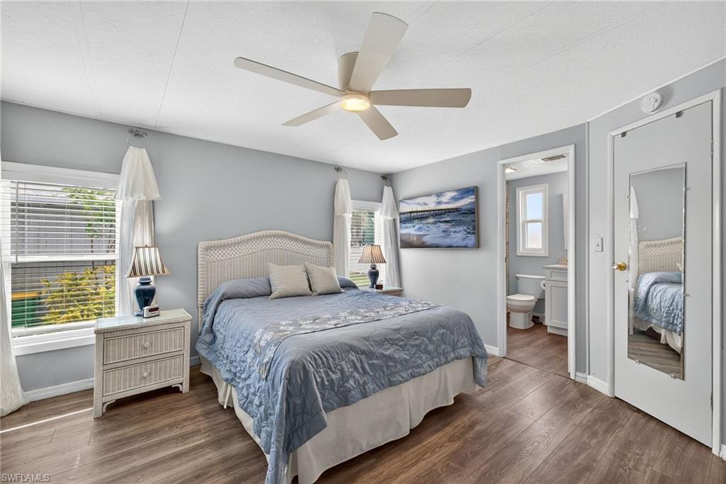 170 Oceans Boulevard, Unit 170 Naples, FL 34104 - Photo 13 of 36 a bedroom with a bed and a large window