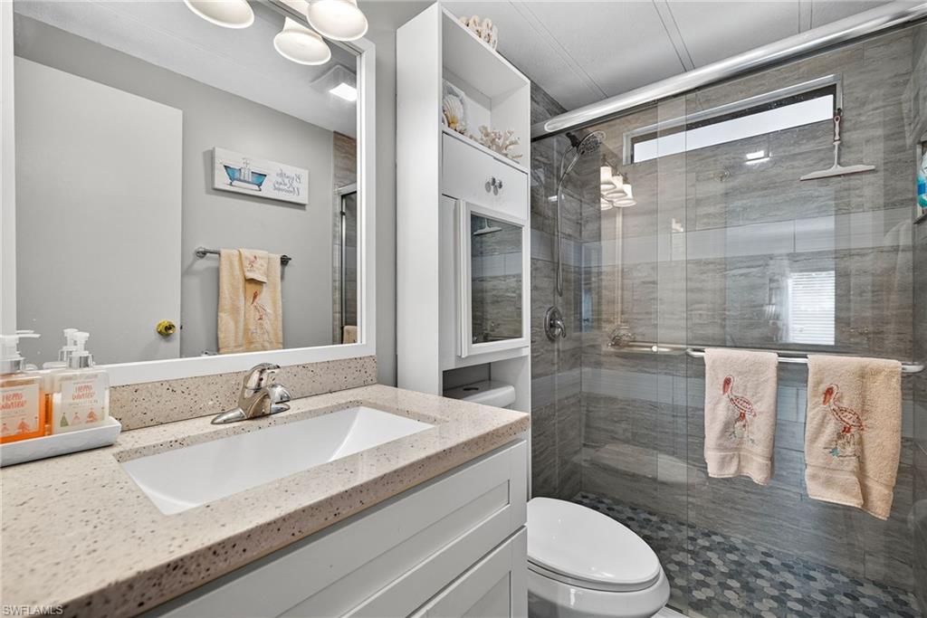 170 Oceans Boulevard, Unit 170 Naples, FL 34104 - Photo 18 of 36 a bathroom with a sink a toilet and shower