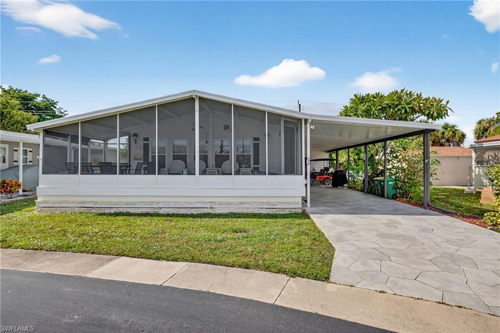 170 Oceans Boulevard, Unit 170 Naples, FL 34104 - Photo 34 of 36 a view of a house with a yard